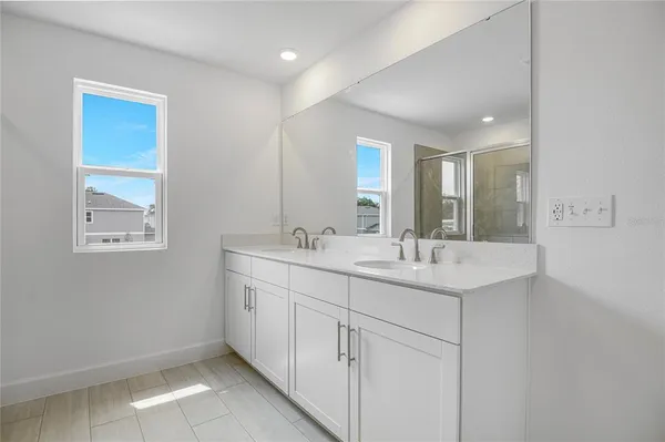 a bathroom with 2 sink and a mirror