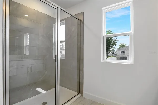 a bathroom with a glass shower door