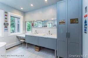 16 Sahler Mill Road Olivebridge, NY 12461 - Photo 33 of 50 a bathroom with a sink mirror and a bathtub