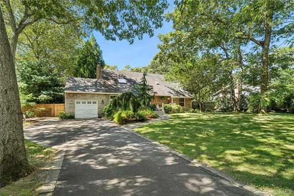 a view of a house with a yard and tree s