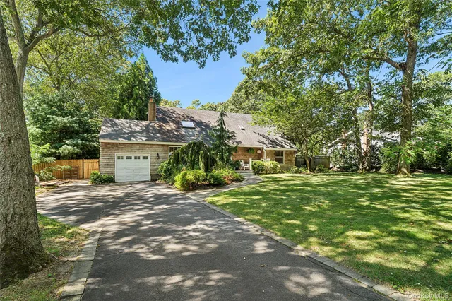 a view of a house with a yard and tree s