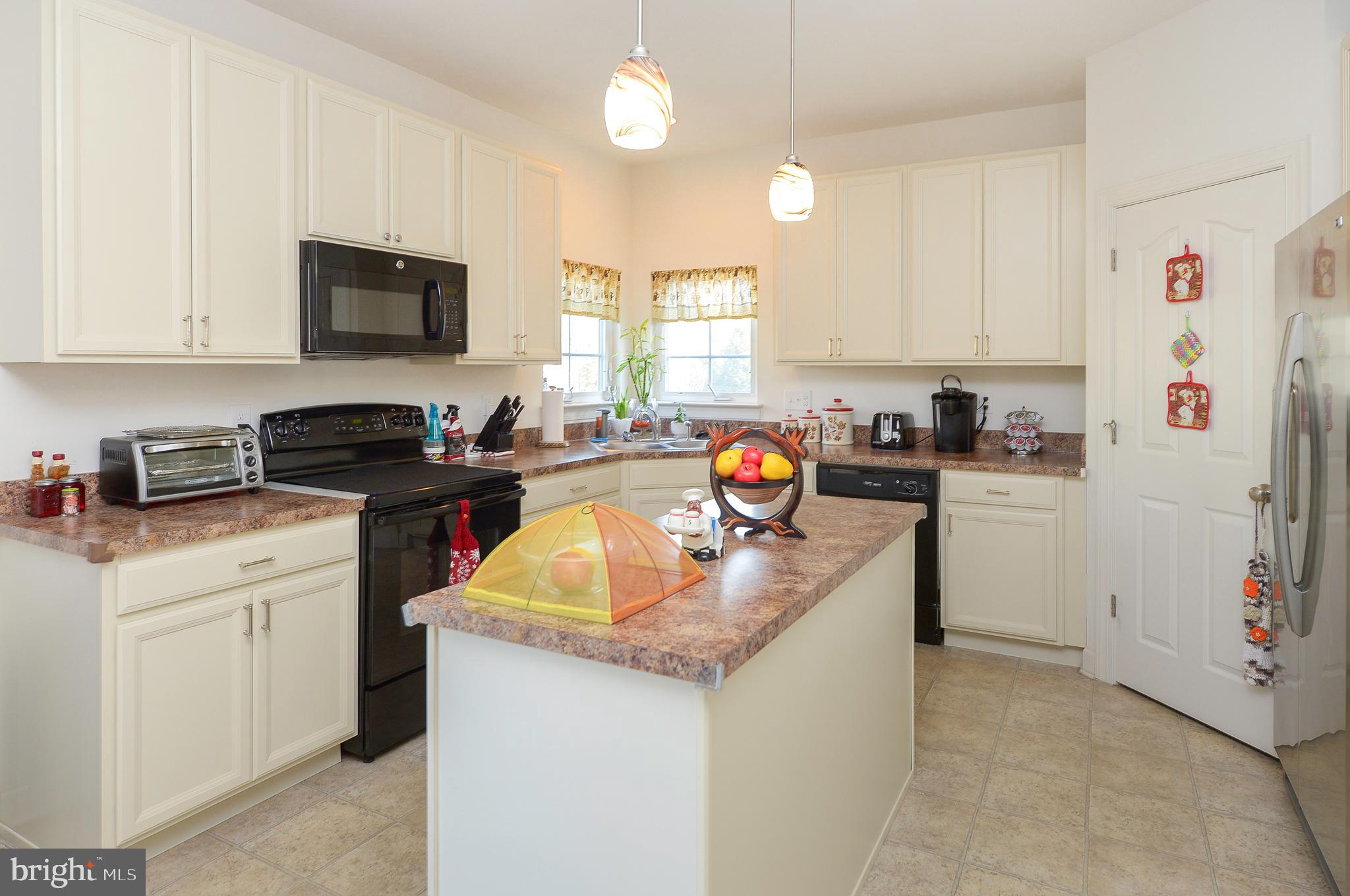 418 Bergenia Loop Bear, DE 19701 - Photo 10 of 27 a kitchen with a sink a stove and refrigerator