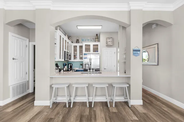 a kitchen with cabinets and wooden floor