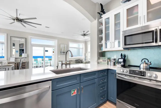 a kitchen with stainless steel appliances granite countertop a sink a stove and cabinets