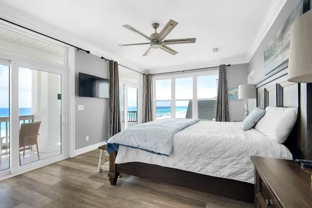 a bedroom with a bed and a large window with a flat screen tv