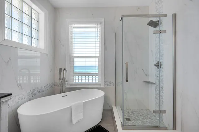 a bathroom with a bathtub and shower