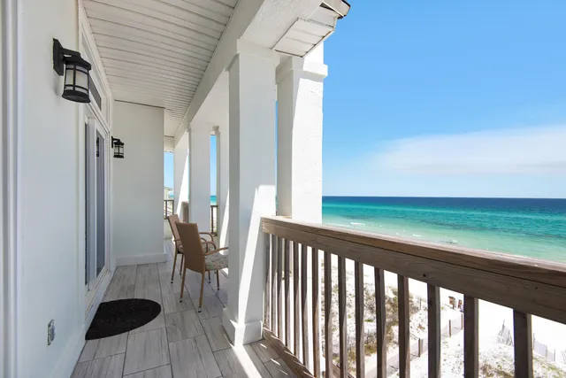a view of a balcony with furniture and wooden floor