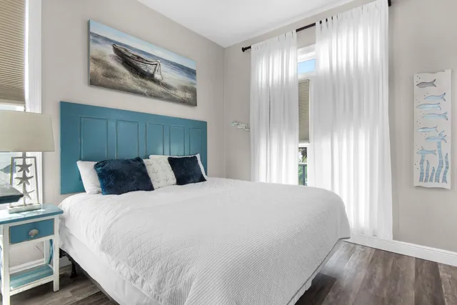 a bedroom with a bed and a painting on the wall