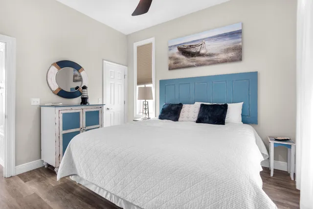 a bedroom with a bed and a painting on the wall