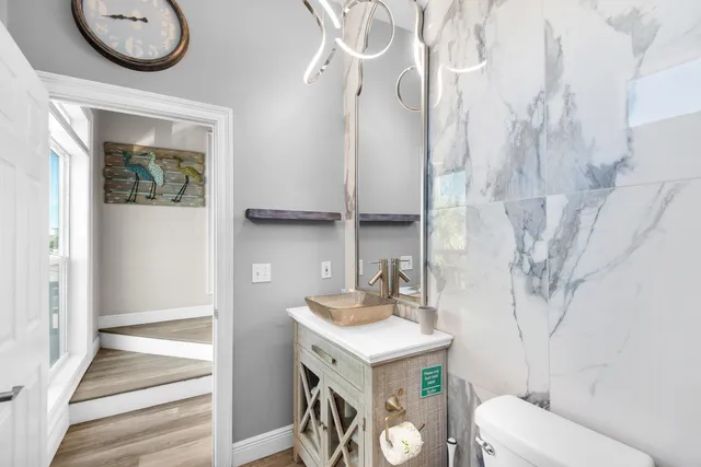 a bathroom with a sink a toilet and a mirror