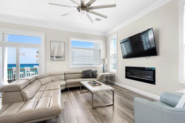 a living room with furniture a flat screen tv and a fireplace