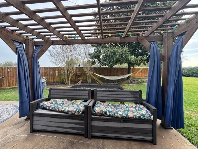 a wooden bench sitting in front of a building