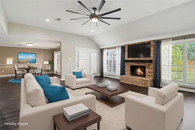 a living room with furniture fireplace and a large window