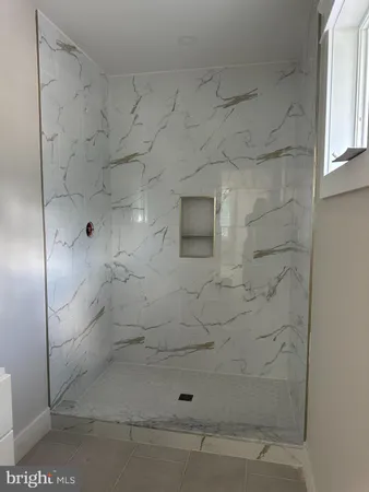 a picture of a bathroom with a shower