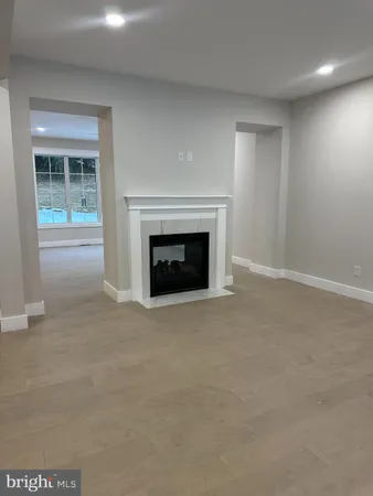 an empty room with furniture and a fireplace