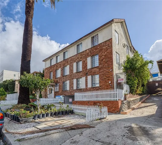 a front view of a building with garden