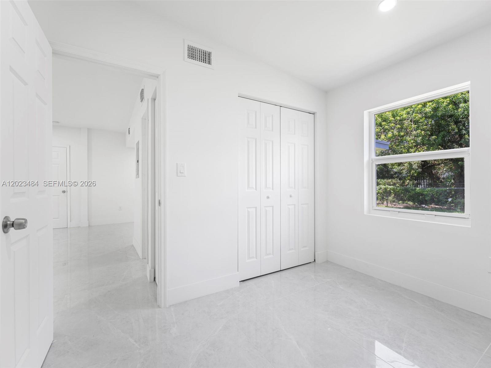1961 Rutland Street Opa-Locka, FL 33054 - Photo 13 of 33 a view of an empty room with a window