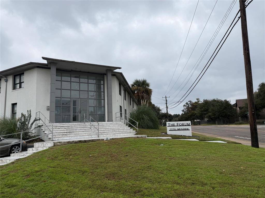 View of home's exterior featuring a yard, stucco siding, and entry steps
