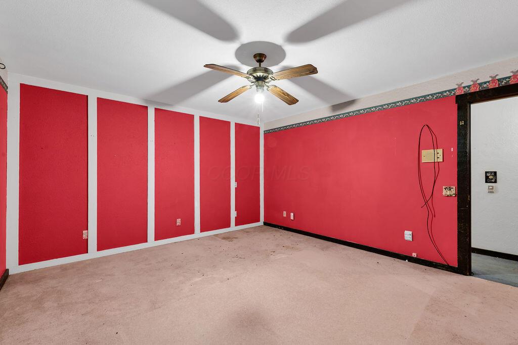 4409 Newton Road Northeast Newark, OH 43055 - Photo 39 of 87 • Light sand carpet • Pink painted walls • Lighted ceiling fan • Closet with bi-fold doors