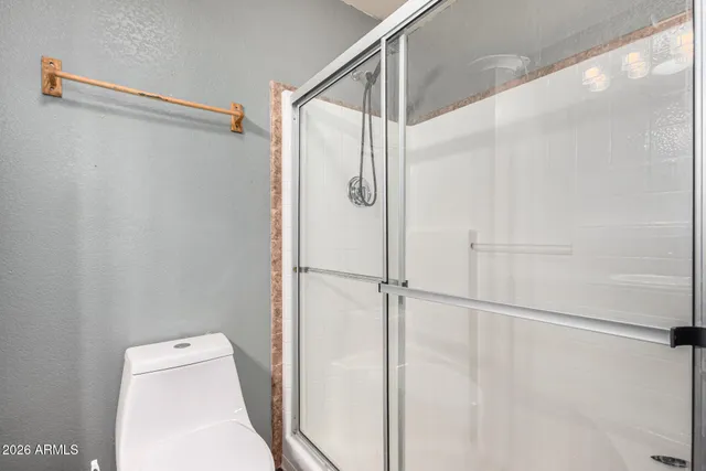 a bathroom with a shower and a shower