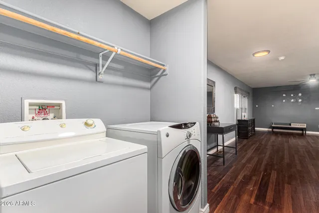 a view of washer and dryer with kitchen in the background