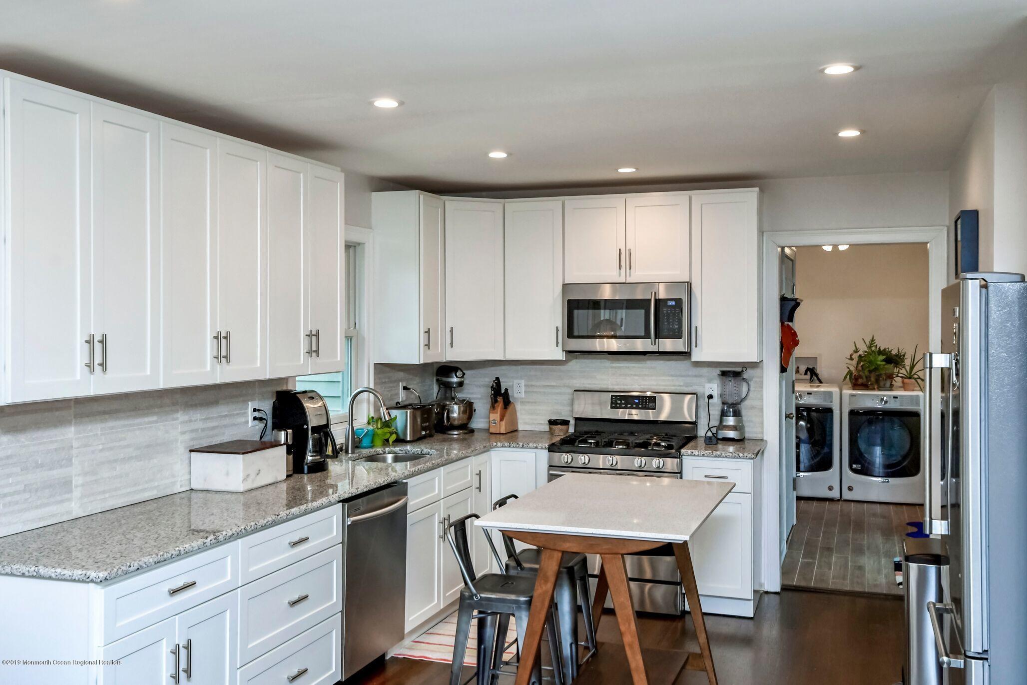 76 Bruce Road Red Bank, NJ 07701 - Photo 11 of 24 a kitchen with stainless steel appliances granite countertop a stove a sink a microwave a refrigerator and cabinets