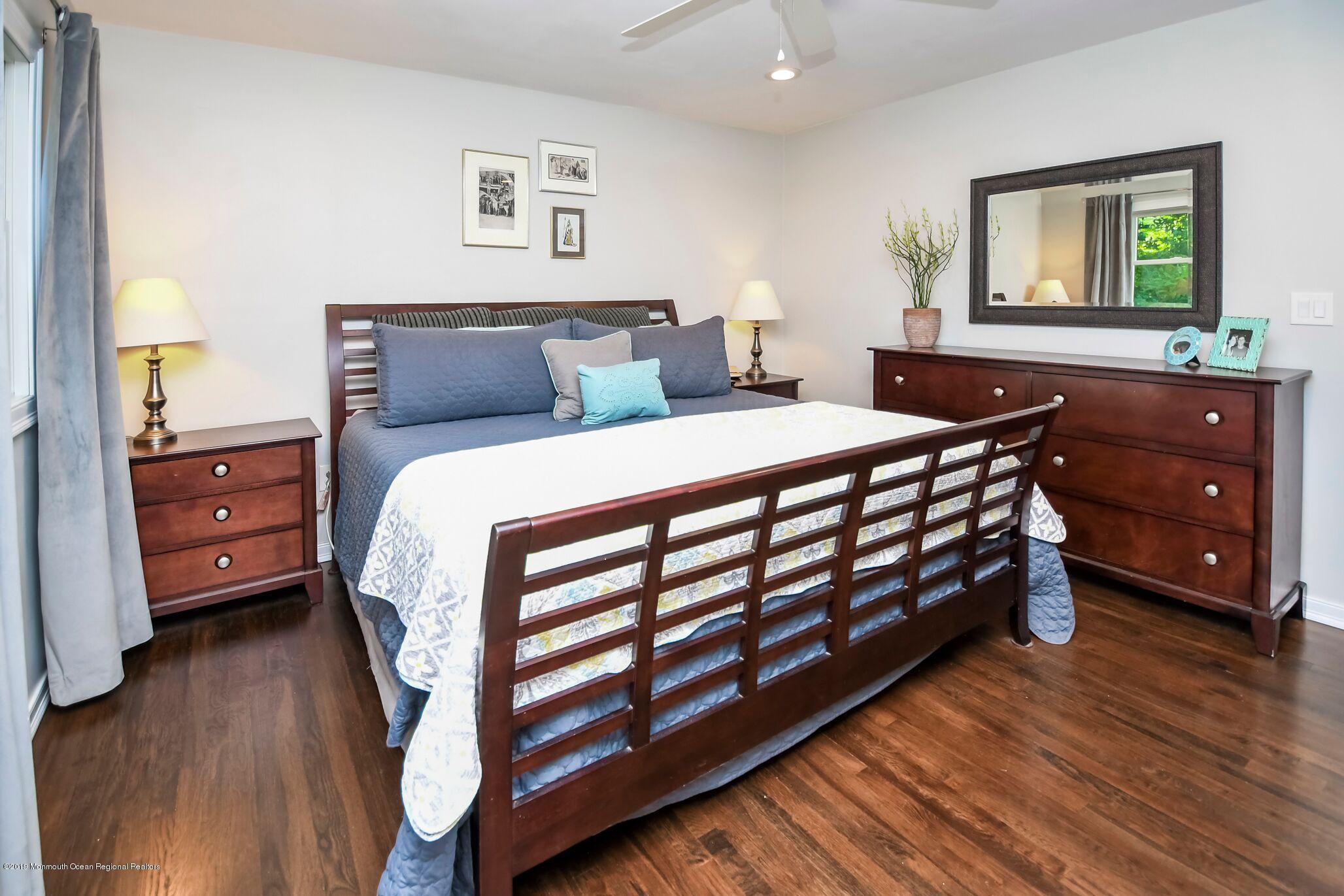76 Bruce Road Red Bank, NJ 07701 - Photo 12 of 24 a bedroom with a bed and a dresser in it