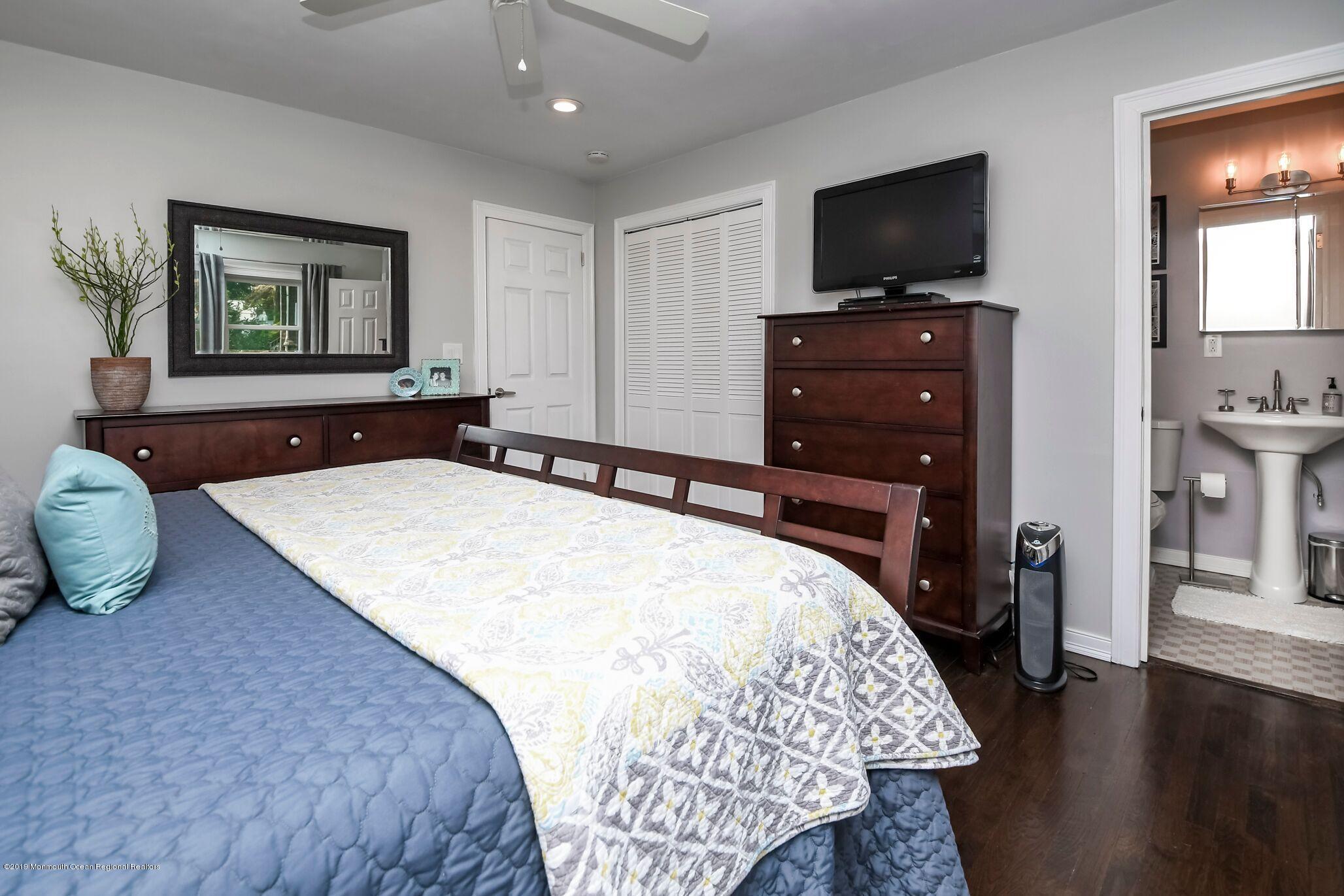 76 Bruce Road Red Bank, NJ 07701 - Photo 13 of 24 a bedroom with a bed and a flat screen tv