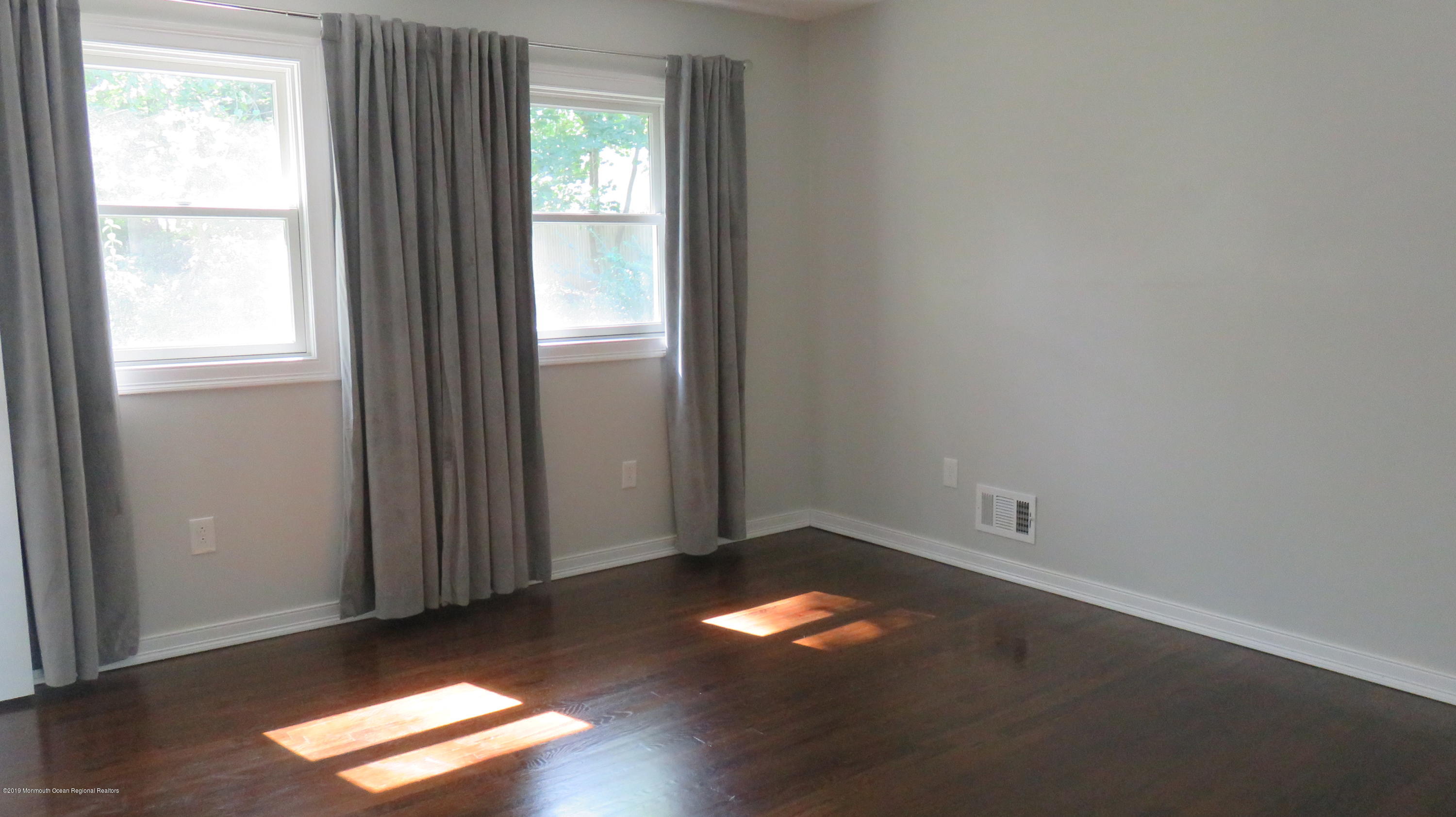 76 Bruce Road Red Bank, NJ 07701 - Photo 14 of 24 an empty room with wooden floor and windows