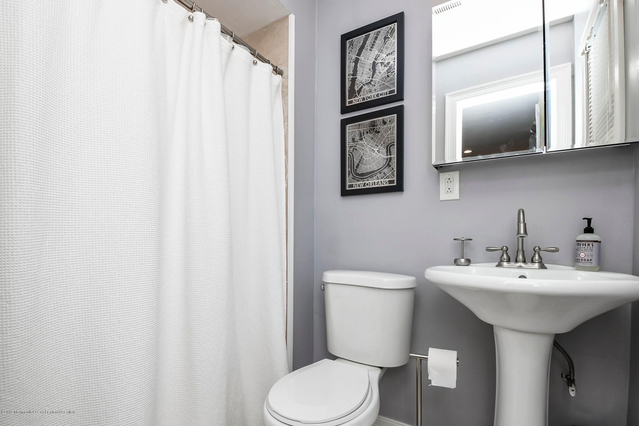 76 Bruce Road Red Bank, NJ 07701 - Photo 15 of 24 a bathroom with a toilet sink and mirror
