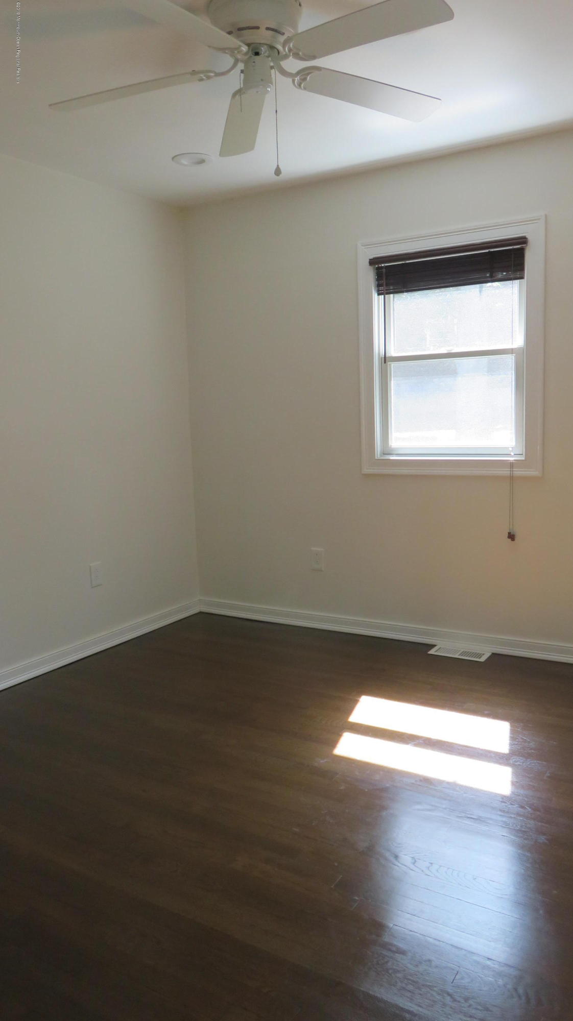 76 Bruce Road Red Bank, NJ 07701 - Photo 17 of 24 an empty room with wooden floor and windows