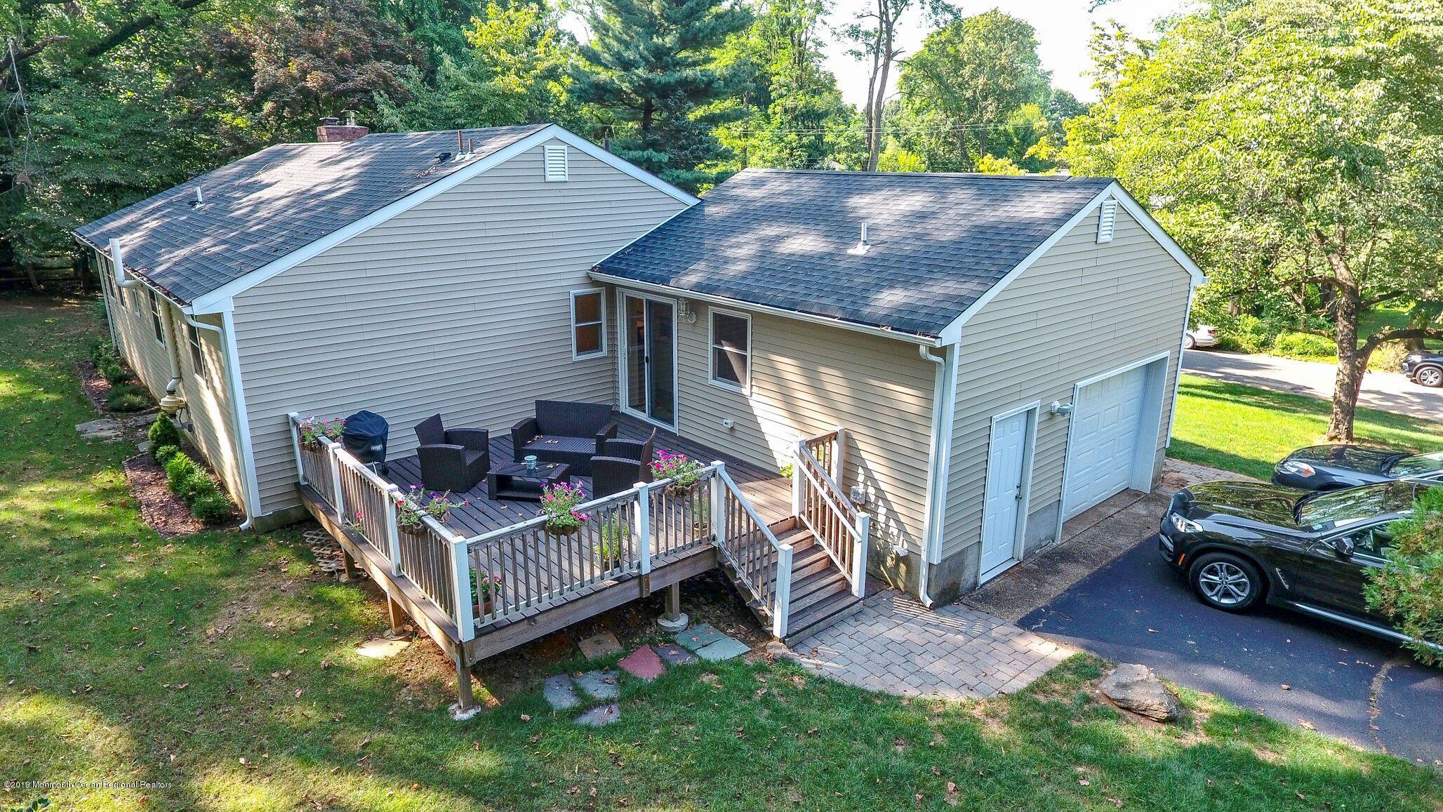 76 Bruce Road Red Bank, NJ 07701 - Photo 20 of 24 a view of a house with a yard and deck area under a large tree