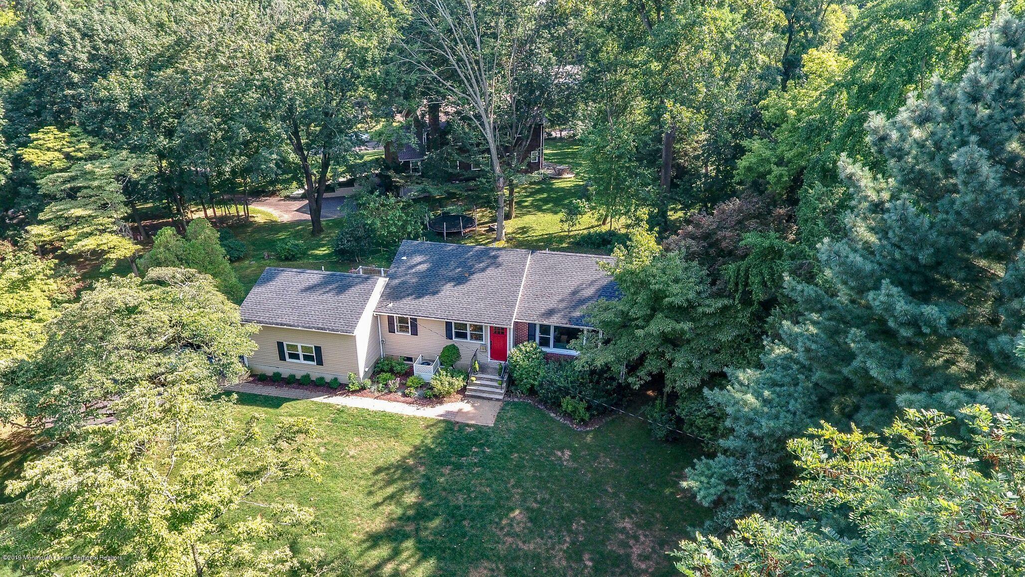 76 Bruce Road Red Bank, NJ 07701 - Photo 23 of 24 a aerial view of a house with garden space and trees all around
