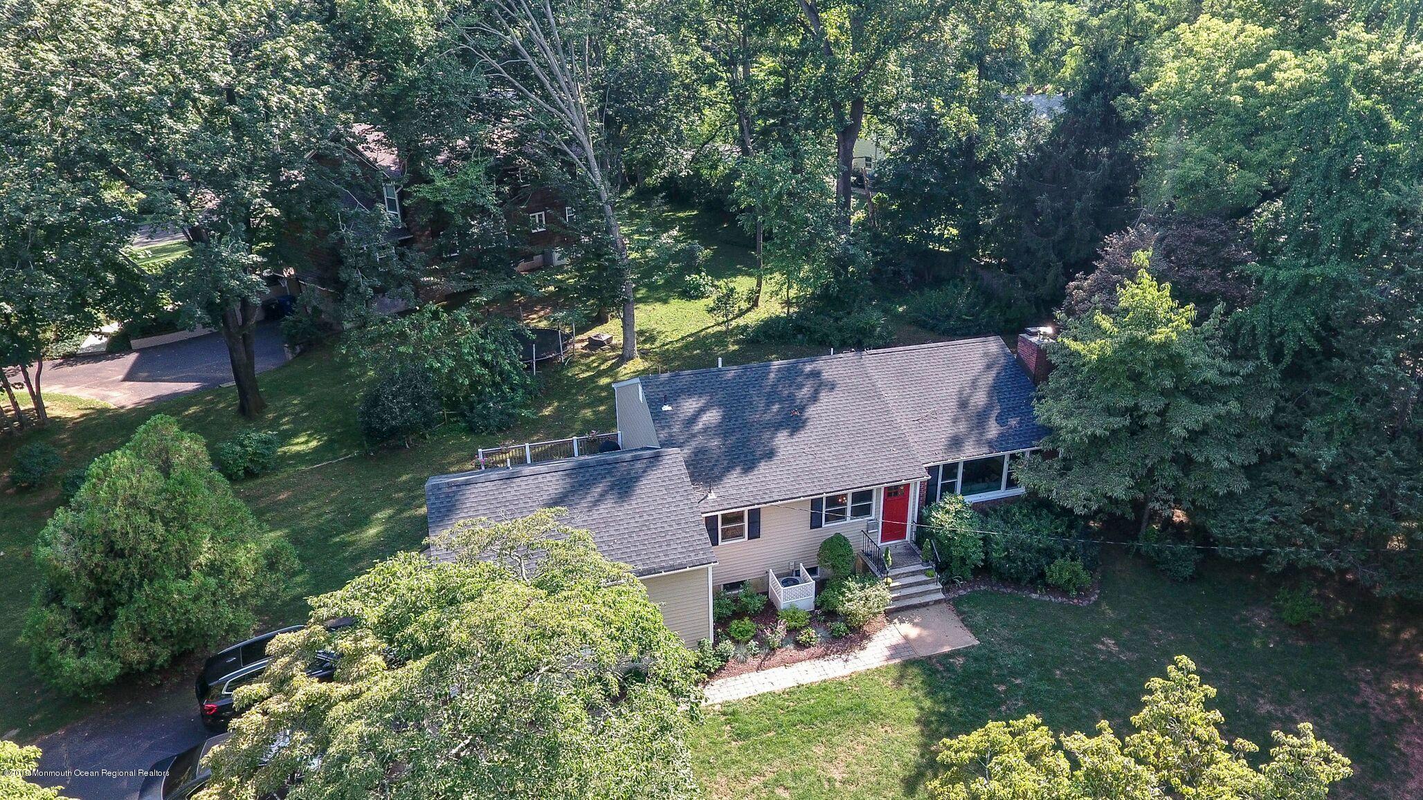 76 Bruce Road Red Bank, NJ 07701 - Photo 24 of 24 an aerial view of a house with a garden and lake view