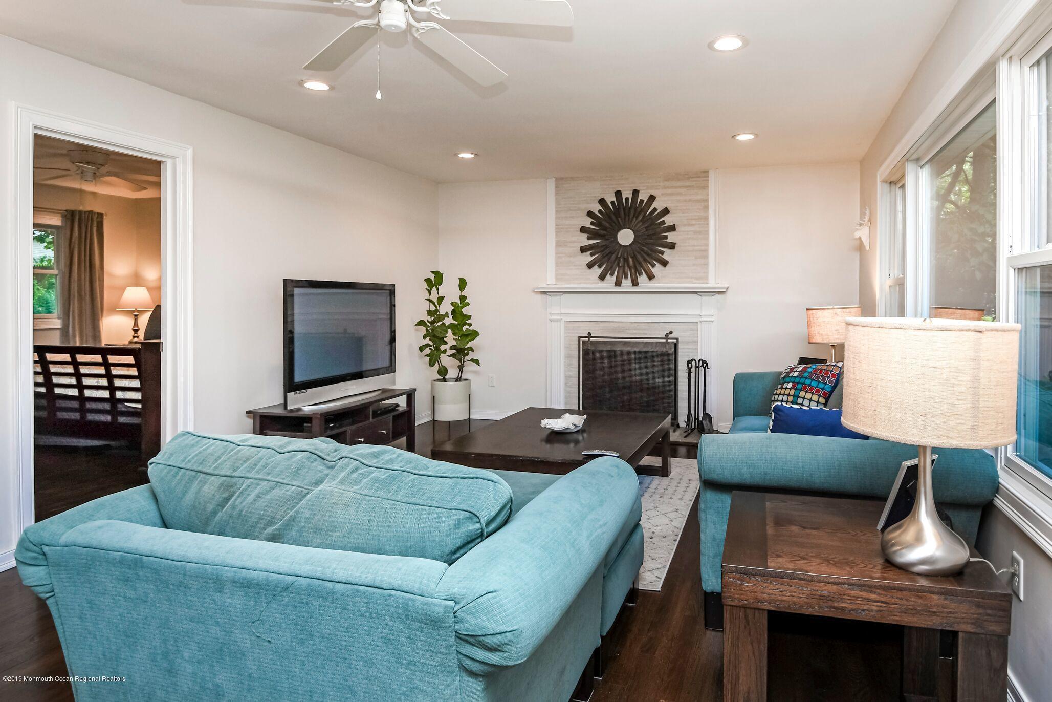 76 Bruce Road Red Bank, NJ 07701 - Photo 6 of 24 a living room with furniture a flat screen tv and a fireplace