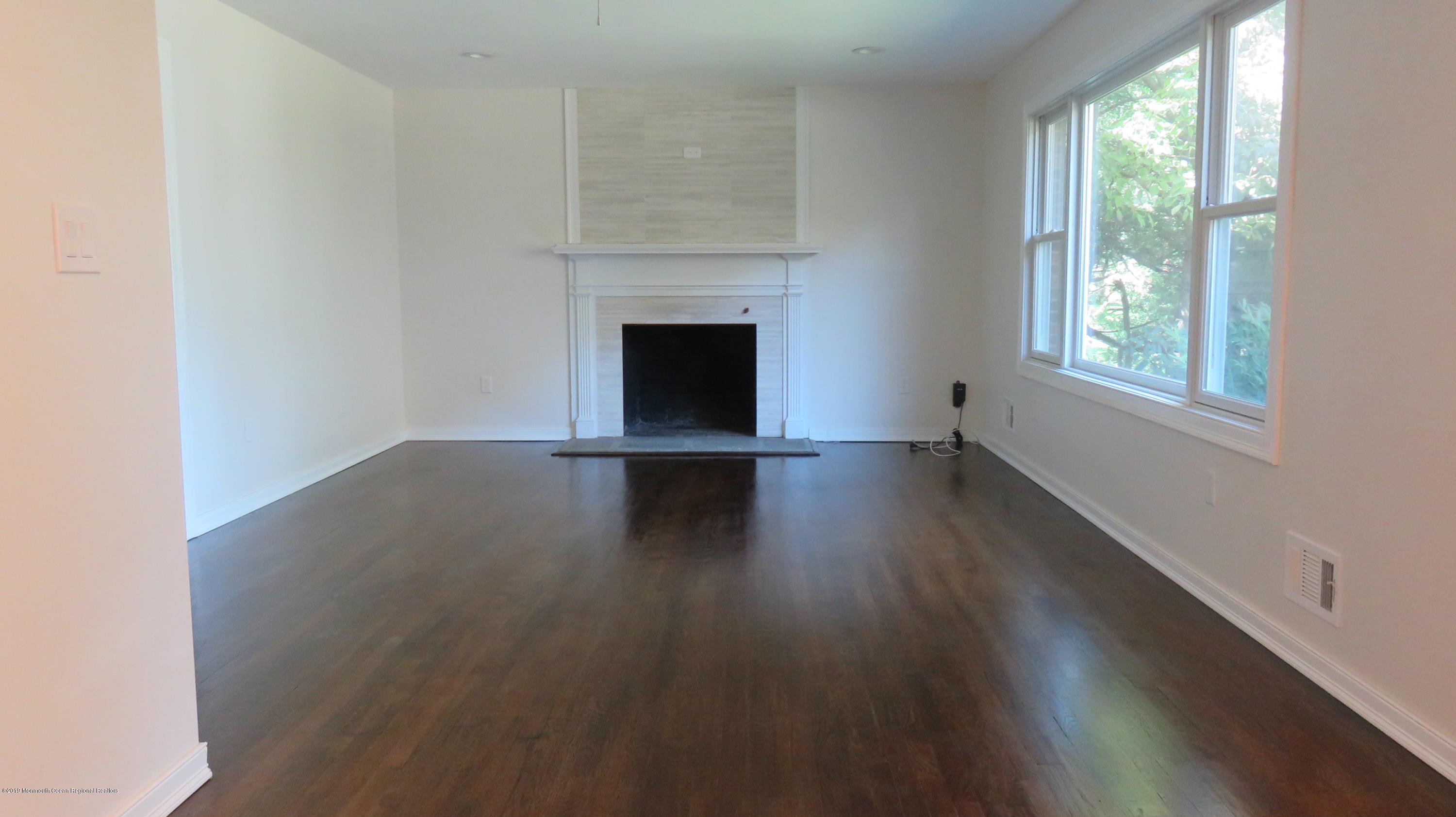 76 Bruce Road Red Bank, NJ 07701 - Photo 7 of 24 an empty room with wooden floor and windows