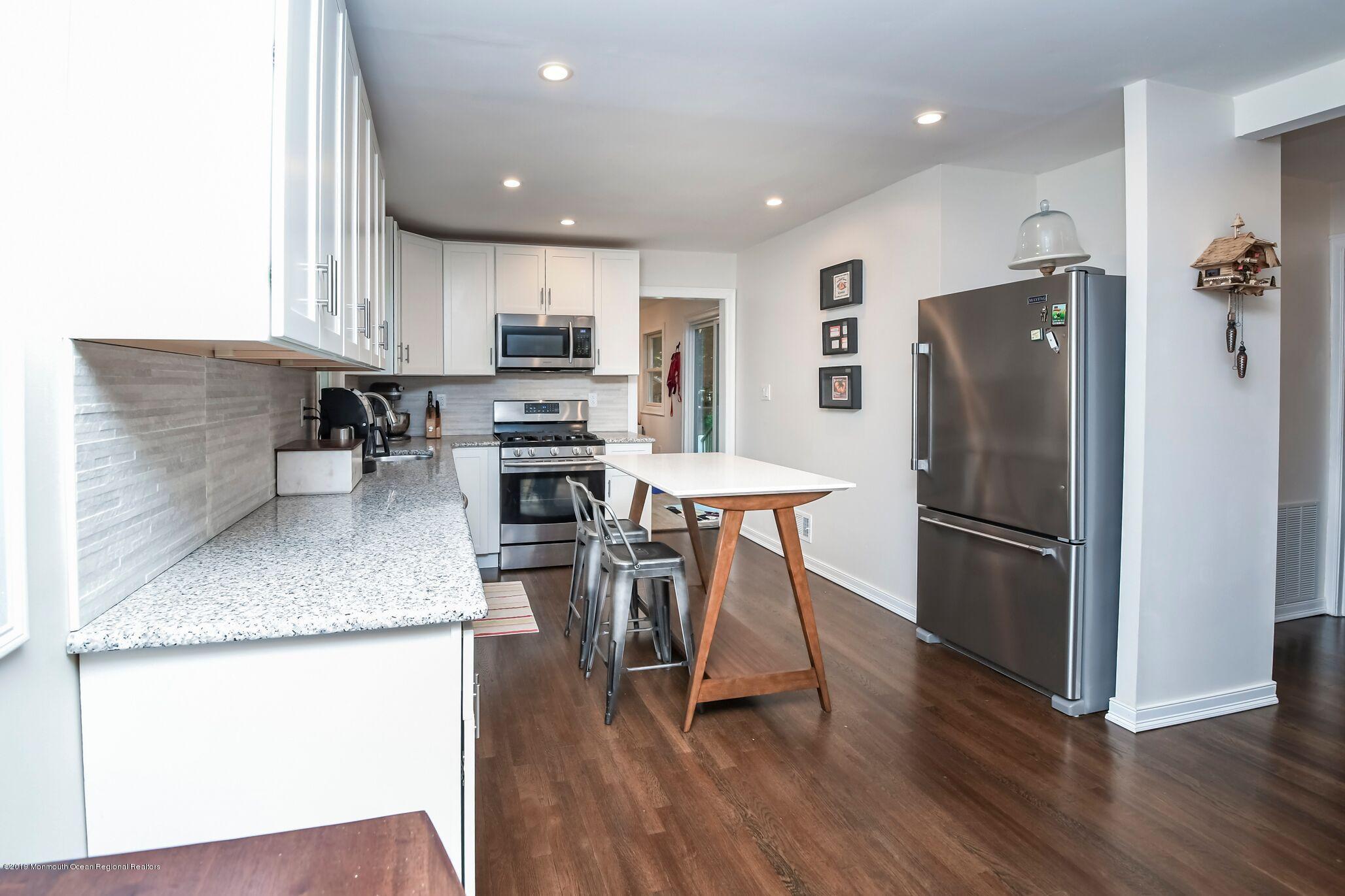 76 Bruce Road Red Bank, NJ 07701 - Photo 10 of 24 a kitchen with stainless steel appliances granite countertop a refrigerator a stove a sink dishwasher and a refrigerator with wooden floor