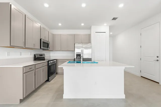 a kitchen with a sink a stove and cabinets