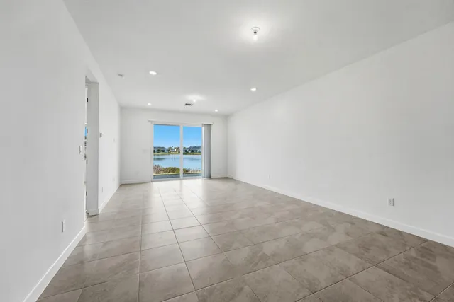 a view of a kitchen with a sink and a refrigerator in it