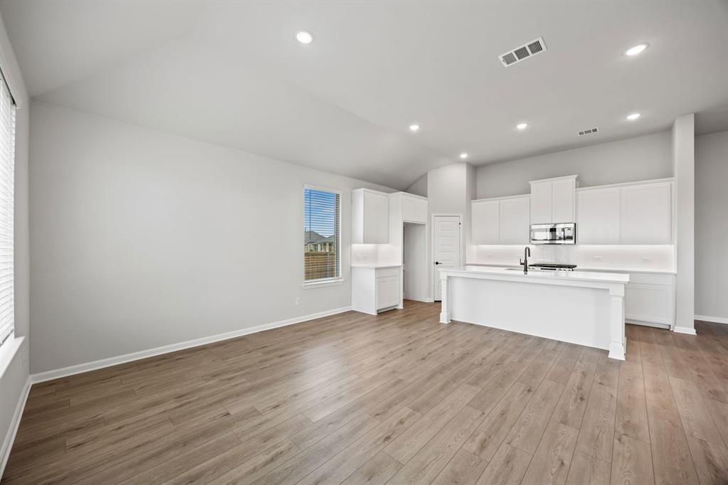 1422 Red Clover Avenue Van Alstyne, TX 75495 - Photo 12 of 30 a view of a kitchen with wooden floor and electronic appliances