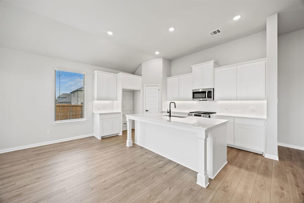 1422 Red Clover Avenue Van Alstyne, TX 75495 - Photo 14 of 30 a kitchen with white cabinets and sink