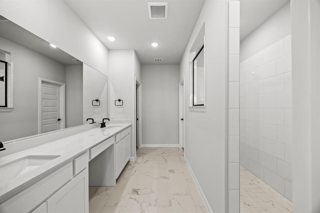 1422 Red Clover Avenue Van Alstyne, TX 75495 - Photo 26 of 30 a spacious bathroom with a double vanity sink and mirror