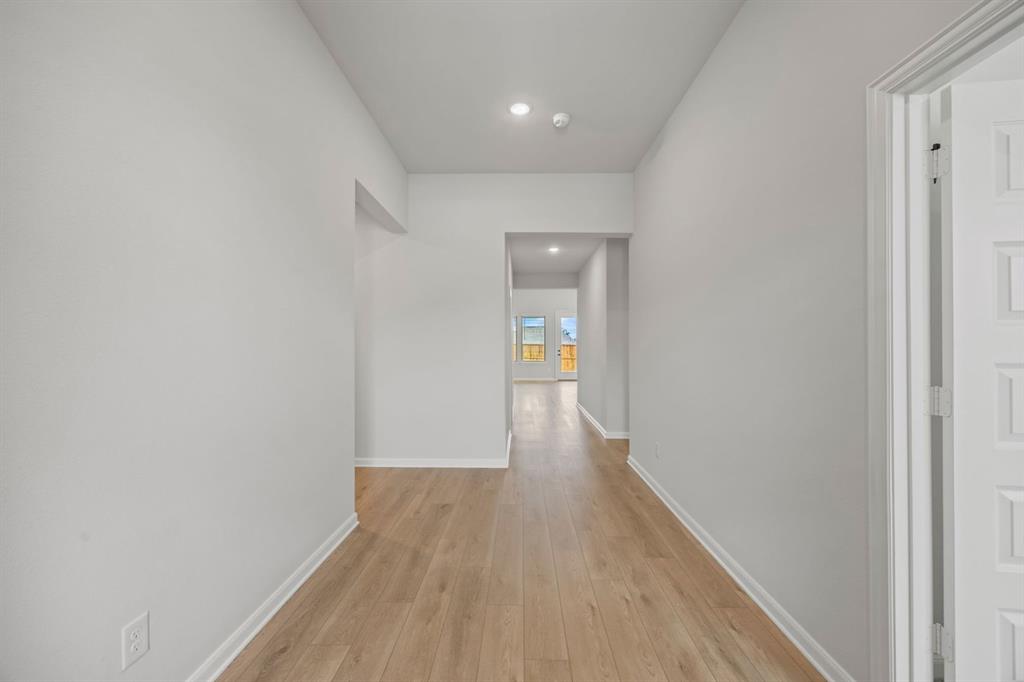 1422 Red Clover Avenue Van Alstyne, TX 75495 - Photo 3 of 30 a view of a hallway with wooden floor