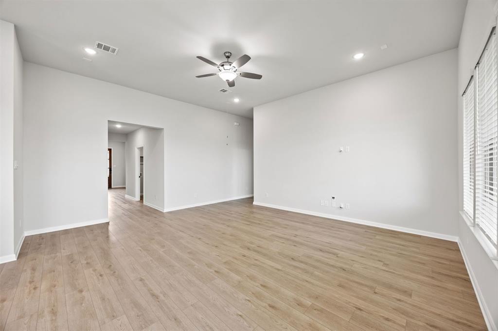 1422 Red Clover Avenue Van Alstyne, TX 75495 - Photo 5 of 30 a view of an empty room with wooden floor and a window