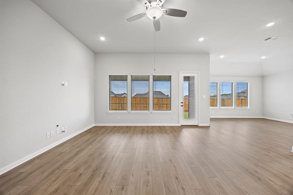 1422 Red Clover Avenue Van Alstyne, TX 75495 - Photo 10 of 30 a view of an empty room with wooden floor and a window