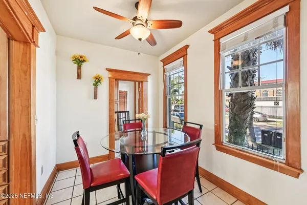 a dining room with furniture a livingroom view and a large window