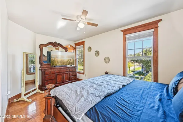 a bedroom with a bed window and a dresser