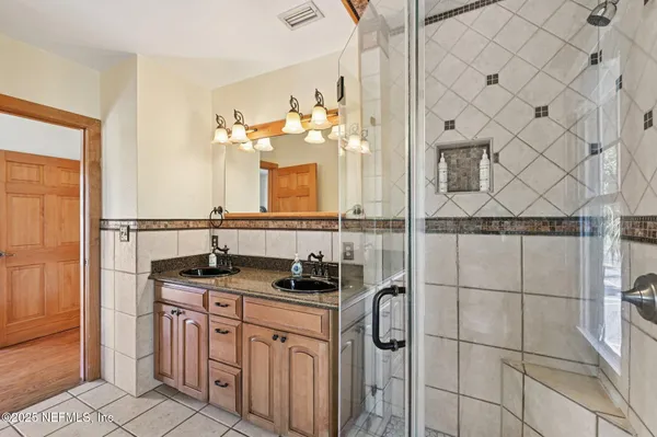 a bathroom with a sink a mirror and a shower