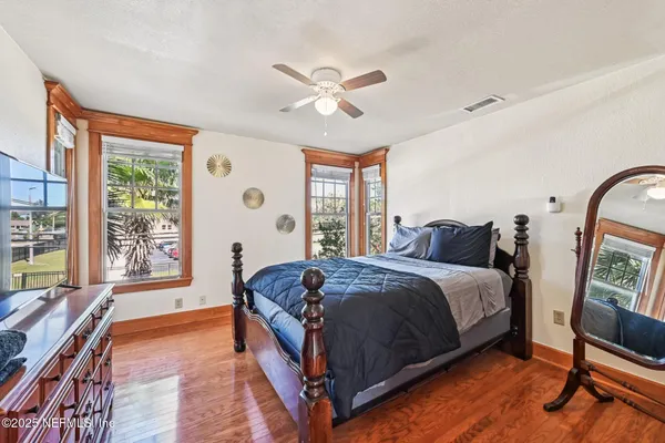 a spacious bedroom with a large bed and a large window