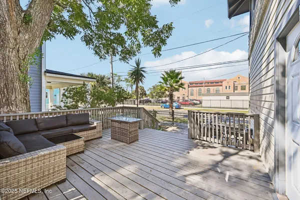 a balcony with furniture and a potted plant
